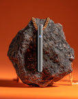 Luxury black vibrator necklace displayed on a stone, combining the discreet elegance of jewelry with the power of a bullet vibrator, mini vibrator, and bullet sex toy