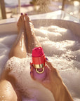 A woman enjoying a bath while holding a rose toy in her hand, demonstrating the waterproof feature and elegant design of the rose sex toy and rose vibrator for discreet intimate pleasure