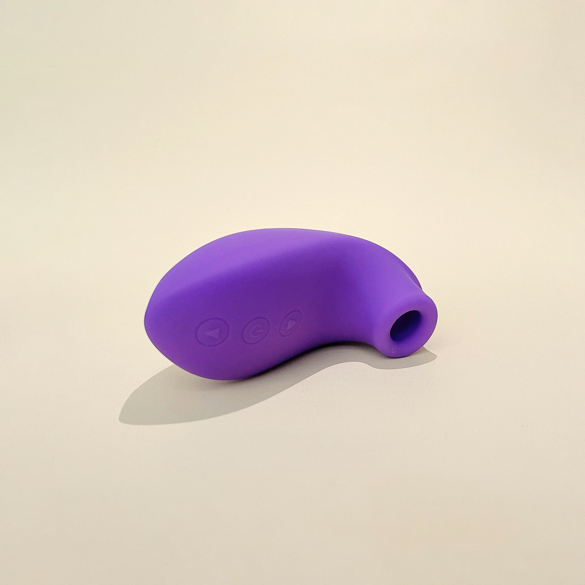 A purple clit stimulator placed on a flat surface